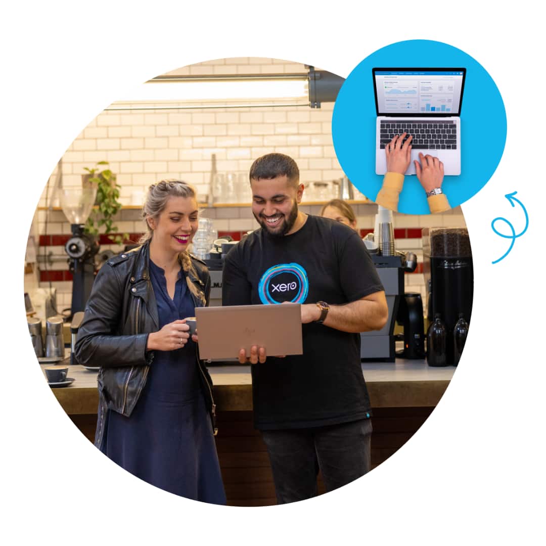 Co-workers check their Xero dashboard on a laptop and share documents online. 